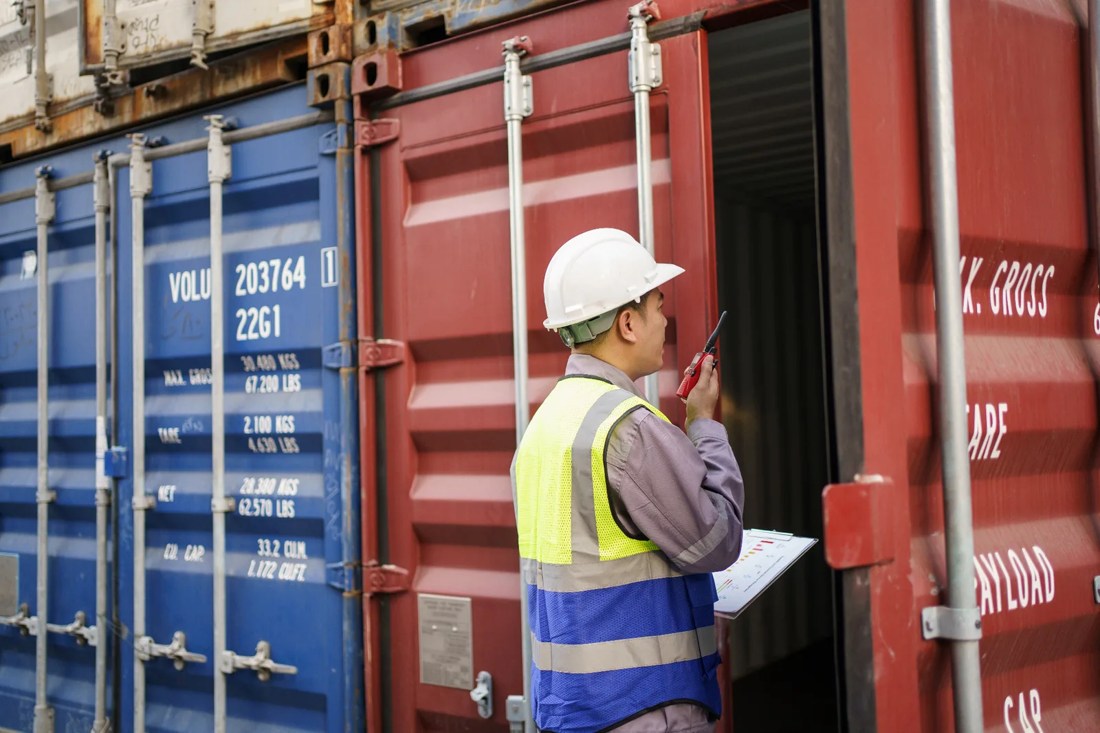 Customs and cargo inspection professional examining an ocean container