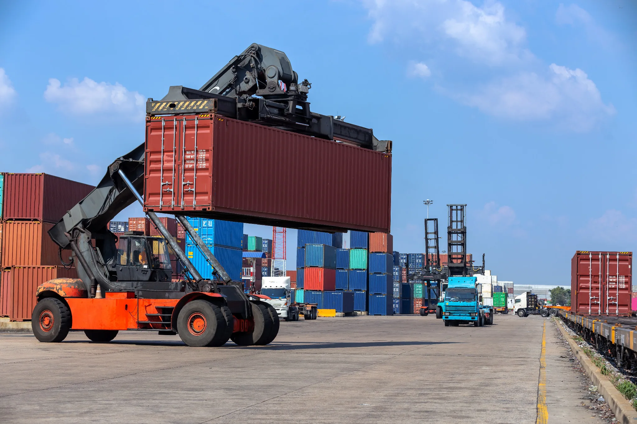 Container handling equipment operating in an intermodal yard