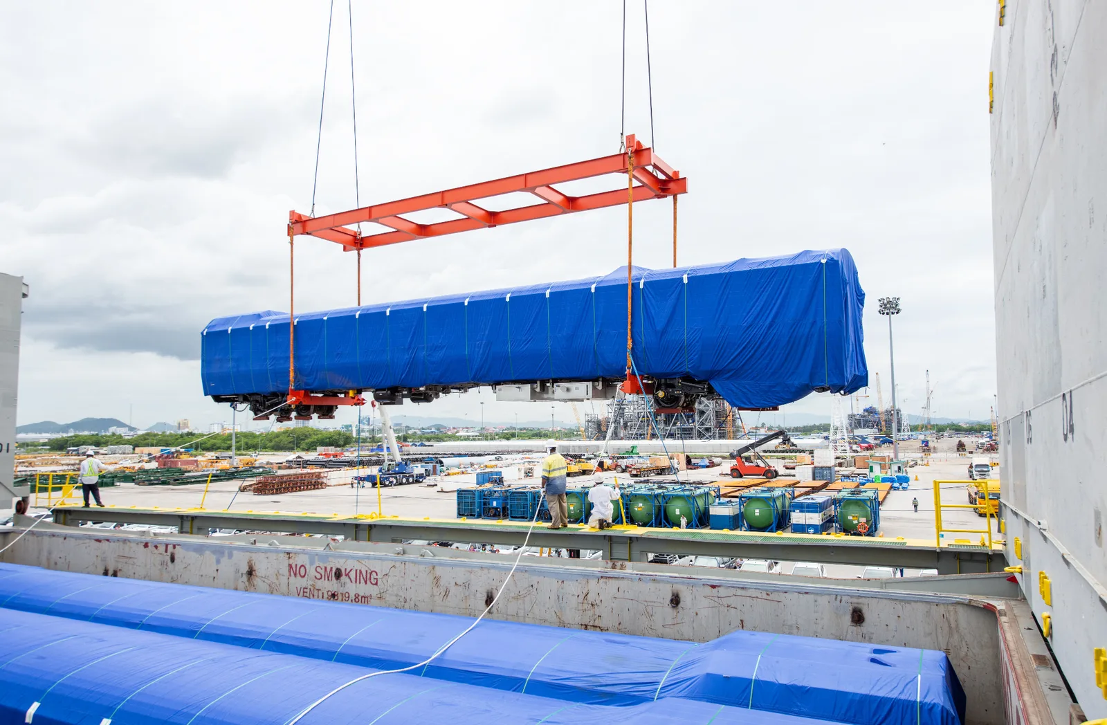 Oversized rail equipment being lifted as project cargo at a port