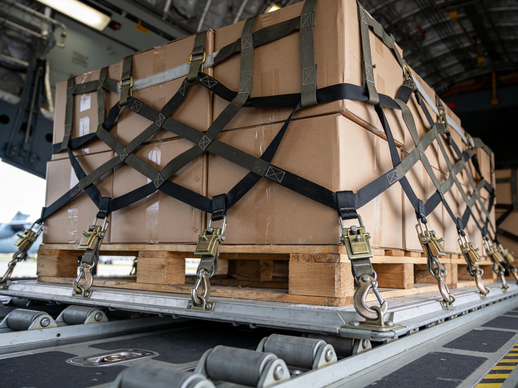 Military cargo prepared for airlift inside a transport aircraft