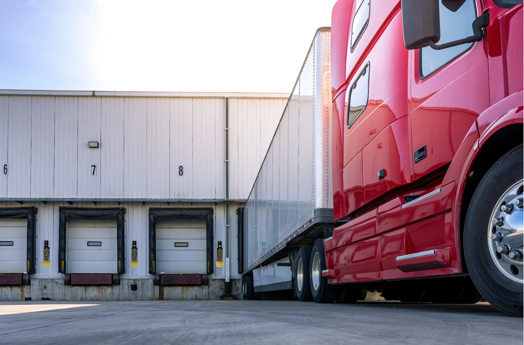 Semi-truck positioned at warehouse loading docks