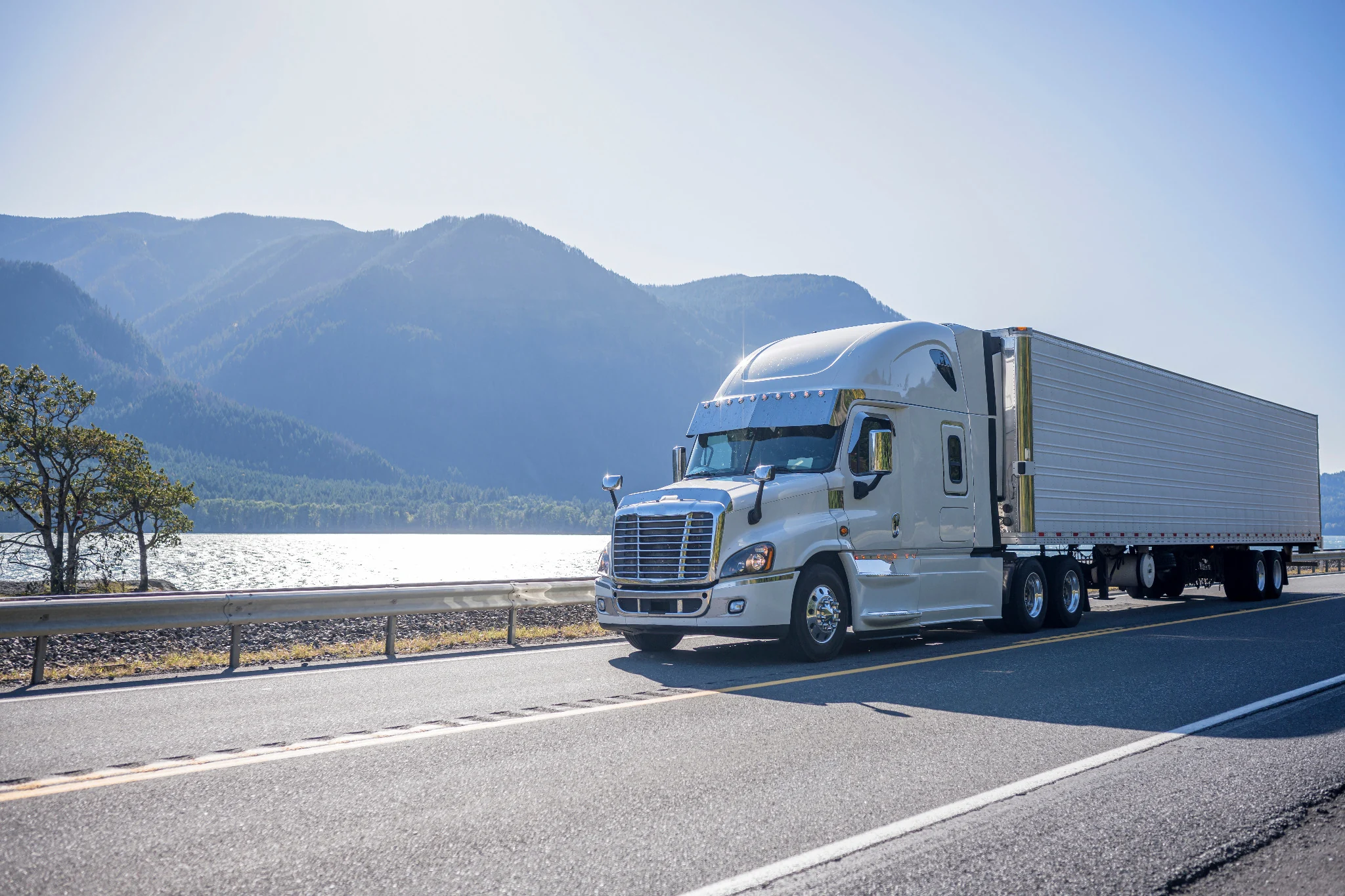 Tractor-trailer traveling through a mountain highway corridor