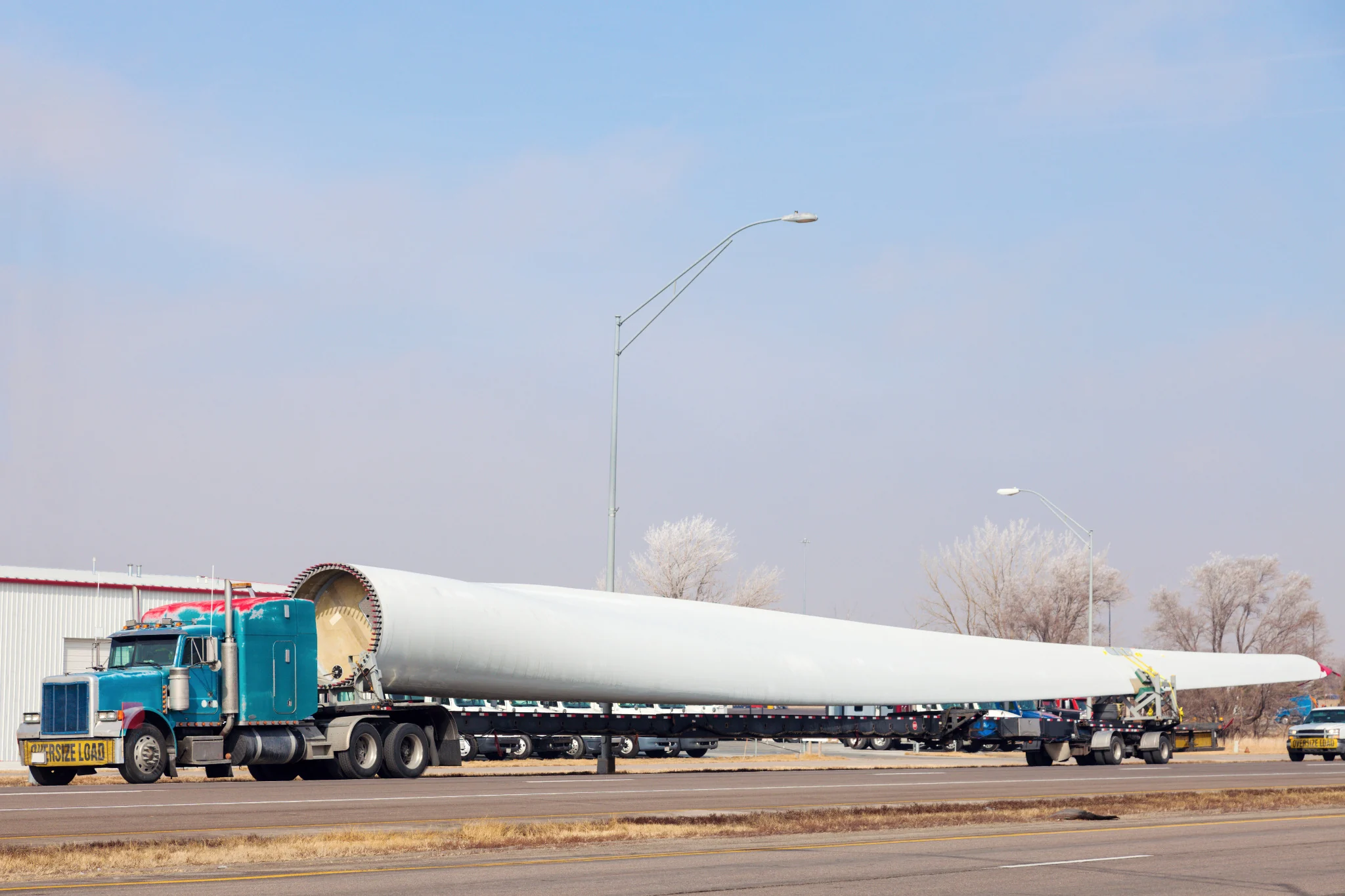 Oversized wind turbine blade transported on specialized trailers